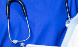 Stethoscope over blue scrubs